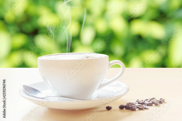 Fototapeta hot coffee with smoke on table