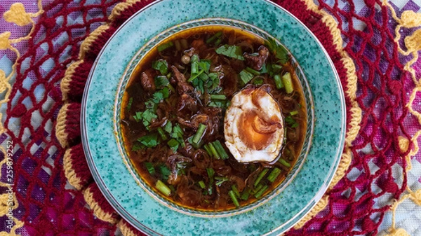 Fototapeta rawon. Indonesian traditional food served with buffalo meat and salted eggs, smeared with black sauce and very tasty