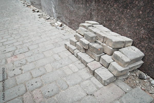 Fototapeta Paving the street in the city. Replacement of old paving tiles. Repairs. Chernivtsi, Ukraine, Europe, March 2019.