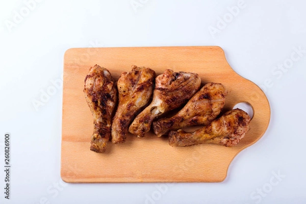 Obraz Grilled chicken shins on a wooden tray