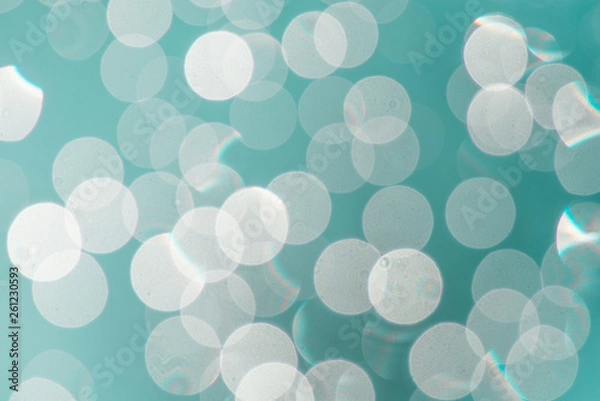 Fototapeta Full-frame image of bright bokeh with a turquoise blue background