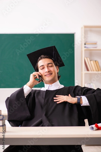 Fototapeta Graduate student in front of green board 