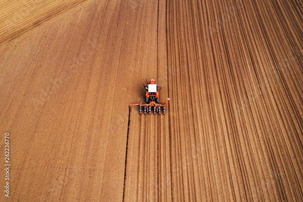 Fototapeta Drone photography of tractor with seeder working in field