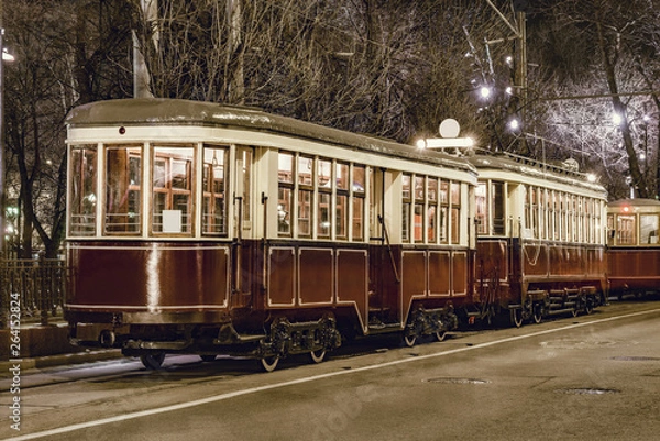 Fototapeta Old vintage tramway car on the night city street.