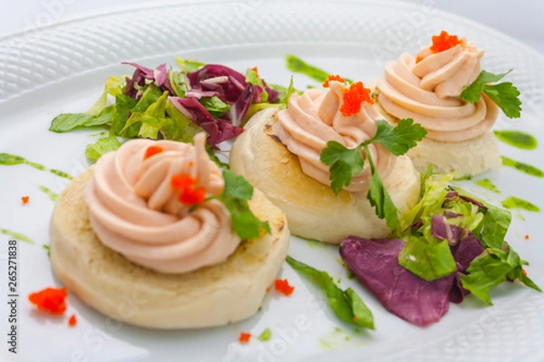 Fototapeta tartlets with red caviar, butter, sprigs of parsley and lettuce on a white plate on a white background