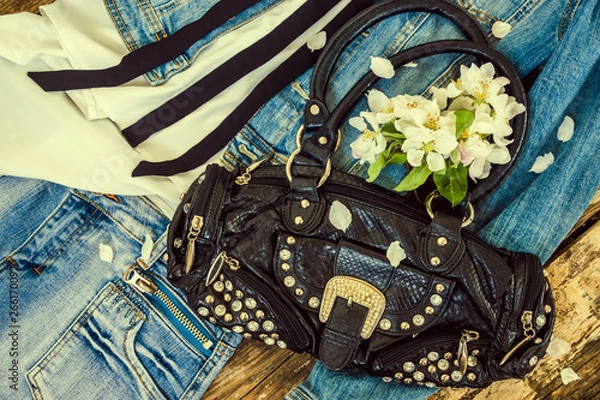 Fototapeta denim jacket, skirt, white shirt, black bag with flowers. Wooden background