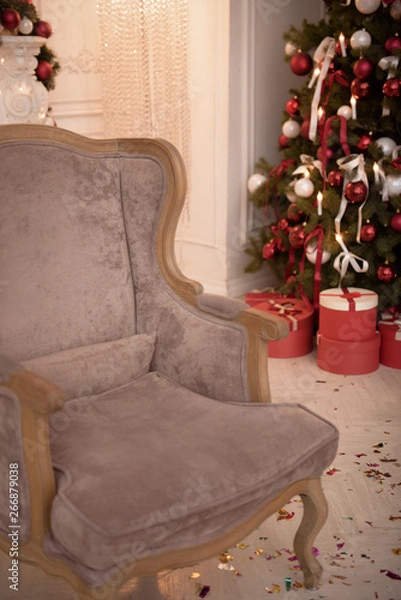 Fototapeta Christmas Tree and Christmas gift boxes in the interior with a fireplace.