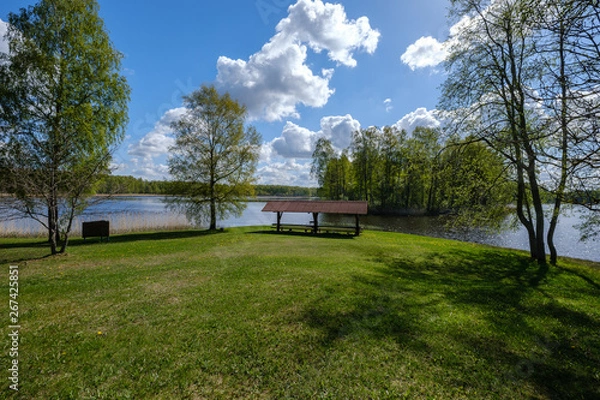 Fototapeta recreation camping area by the blue lake in sunny summer day