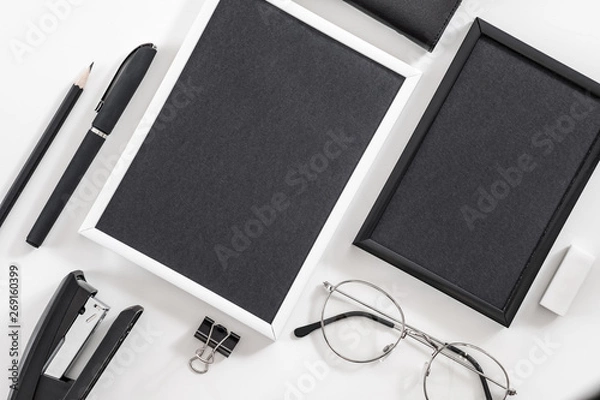 Obraz Business life essentials. Office supplies set. Flat lay of blank photo frames, eyeglasses, stationery. Mockup.