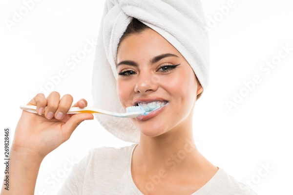 Obraz Teenager girl over isolated white background brushing her teeths