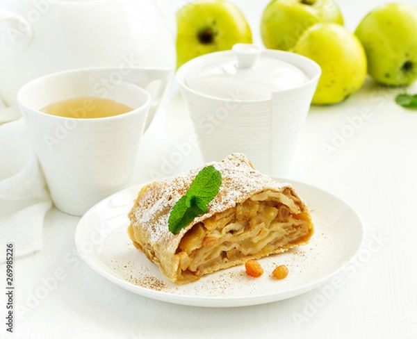 Fototapeta apple strudel with cinnamon and an ice cream ball.