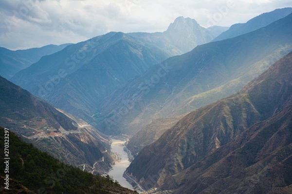 Fototapeta Landscape Scenery on the road between Lijiang and Shangri-La, Yunnan Province China. High Altitude Mountains, small village, Tibetan culture. Bright Blue Sky, natural Chinese landscape. China Travel