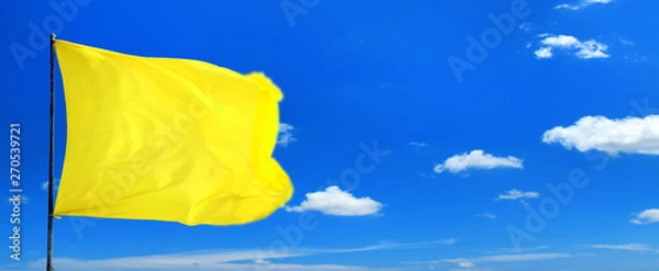 Fototapeta Conceptual image of waving blank yellow flag over sunny blue sky