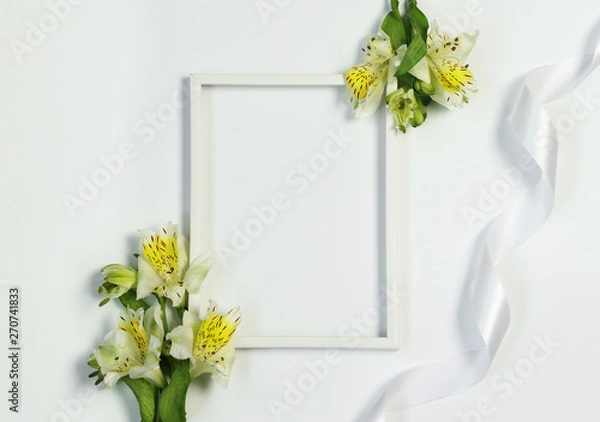 Fototapeta Mockup photo frame with flowers and ribbon on white background