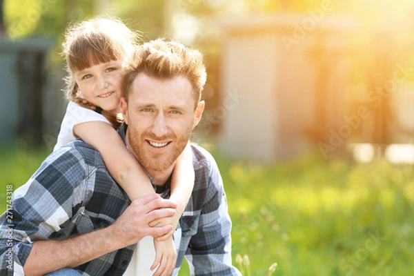 Fototapeta Portrait of happy father and his little daughter outdoors