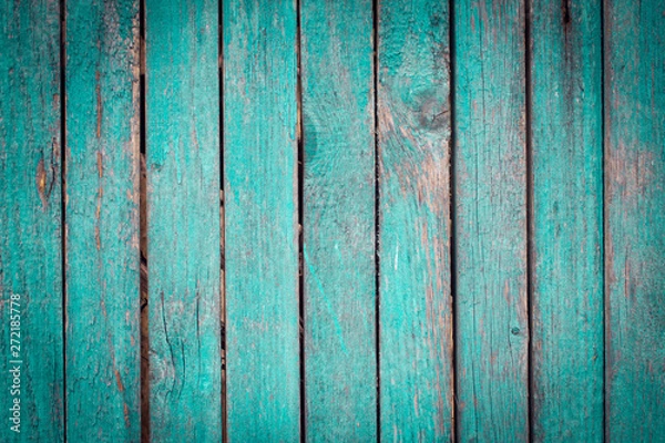 Fototapeta old shabby wooden green fence in the street