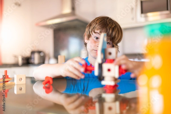 Fototapeta Young boy playing to build at home