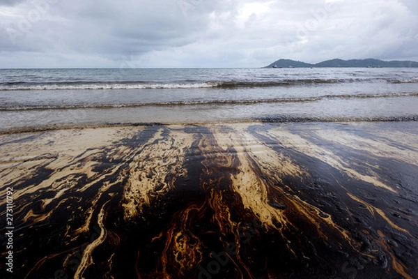 Fototapeta Petroleum spill mixed with other chemical substances on sea and sand surface. Pollution images, Samet Island, Thailand.