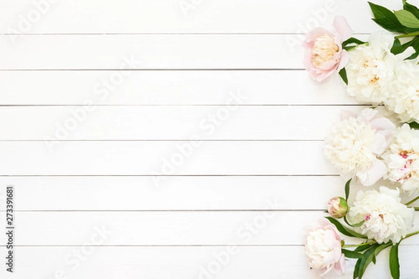 Obraz White peonies on wooden background. Copy space, top view.