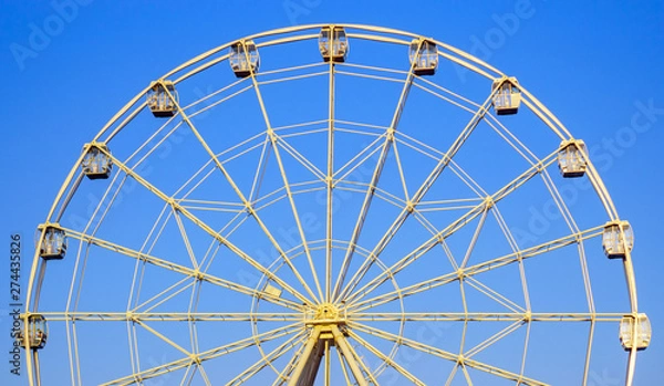 Fototapeta Ferris wheel in summer in the blue sky