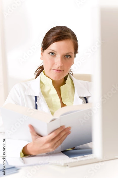 Fototapeta Female doctor read book in clinic