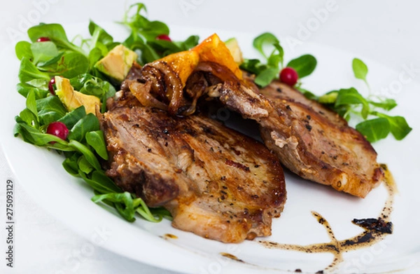 Fototapeta Close up of delicious fried pork chops with avocado and berries