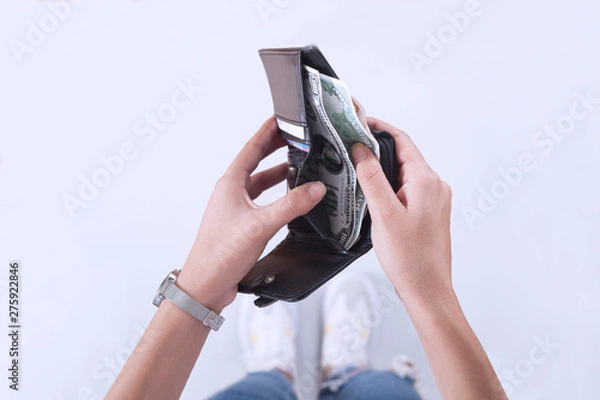 Fototapeta Woman taking out euro money from her pocket wallet top view