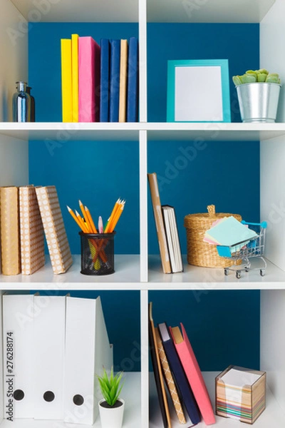 Fototapeta Stacks of supplies and paperwork in the office and bookshelves