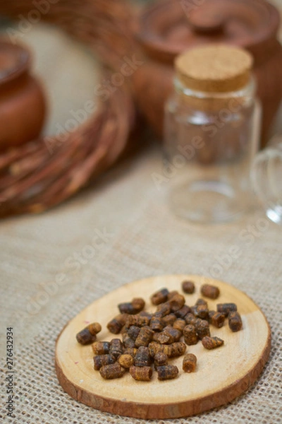 Fototapeta ambrosia on a wooden board on a wicker table and glass jar