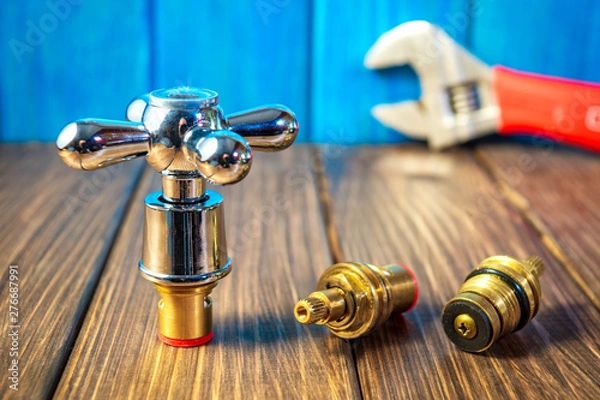 Fototapeta Plumbing supplies and tools on a blue wooden and vintage background.