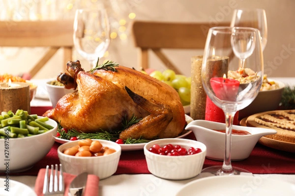 Fototapeta Traditional festive dinner with delicious roasted turkey served on table