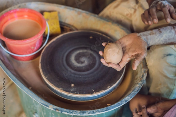 Fototapeta Boy doing ceramic pot in pottery workshop