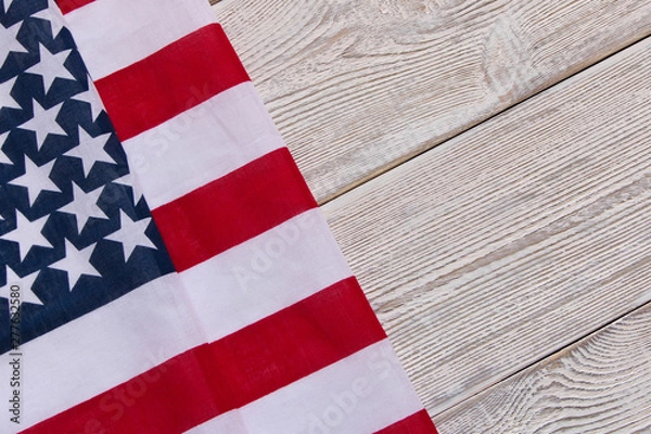 Fototapeta American flag on a wooden background. The concept of freedom and patriotism.