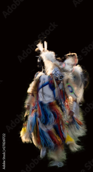 Fototapeta Motion blurred image of a Native Americans powwow dance on black background