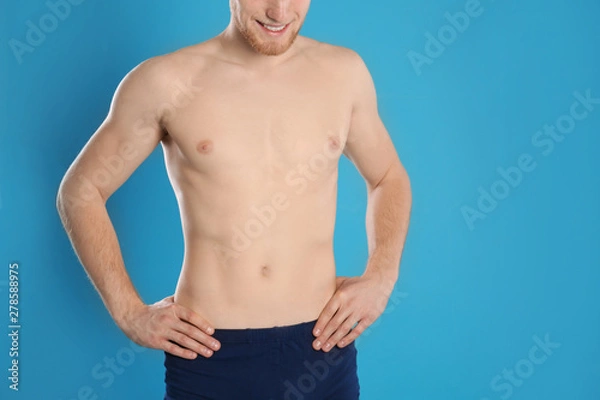 Fototapeta Man with slim body on color background, closeup