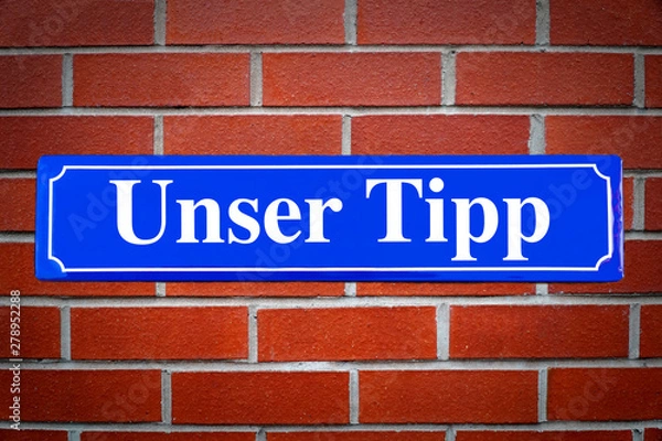 Fototapeta Unser Tipp Schild blau an Backsteinwand