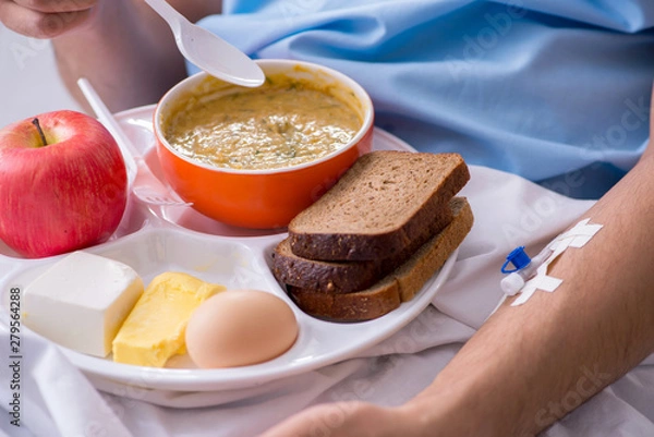 Fototapeta Male patient eating food in the hospital