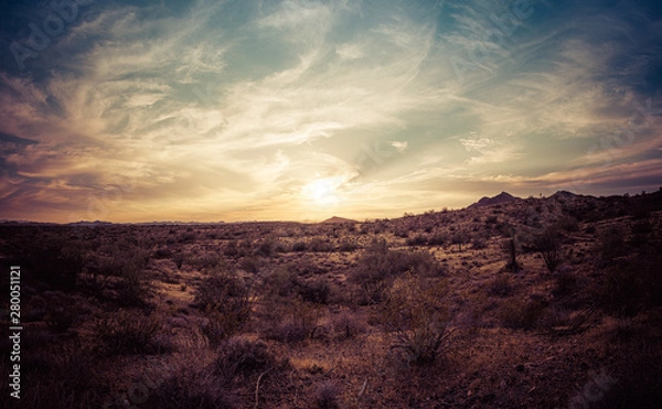 Fototapeta A sunset over the Sonoran Desert of Arizona with high altitude clouds panorama.