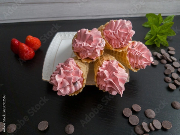 Fototapeta marshmallows in a cone with mint and strawberries