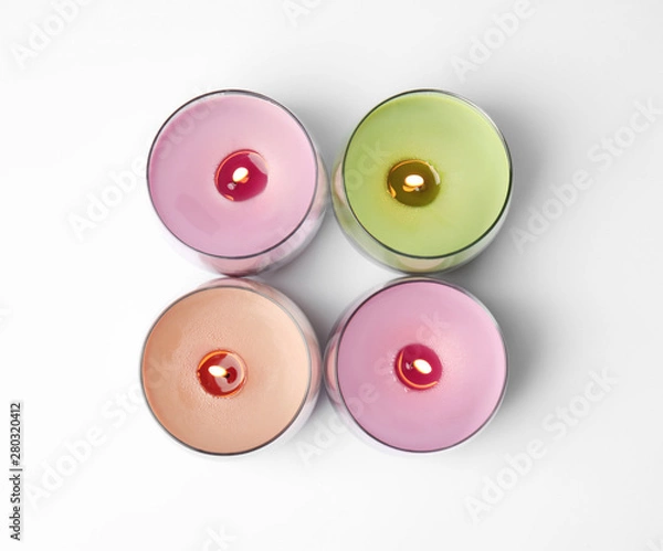 Fototapeta Color wax candles in glass holders isolated on white, top view