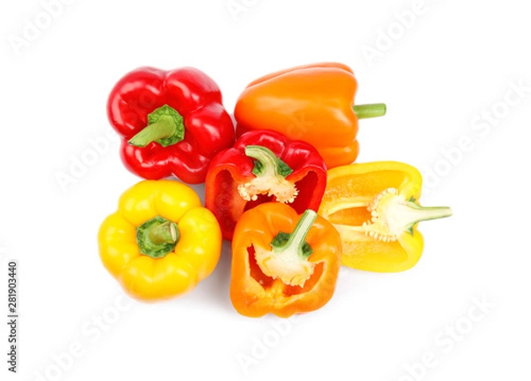 Fototapeta Whole and cut bell peppers on white background, top view