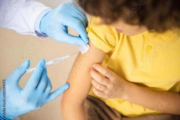 Fototapeta Child given shot by practitioner stock photo