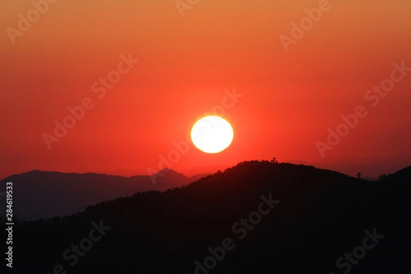 Fototapeta Sunset in sky and cloud, beautiful colorful twilight time with silhouette of mountain.