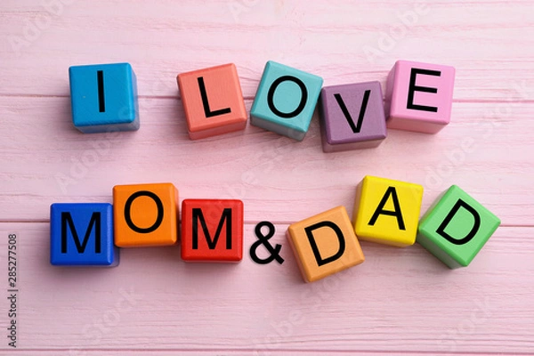 Obraz Words I LOVE MOM and DAD made from alphabet cubes on pink wooden table, flat lay