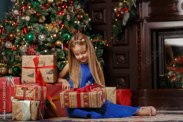 Fototapeta Little blonde girl in blue dress, new year