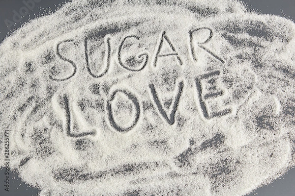 Fototapeta Beautiful background of sugar with the word love.