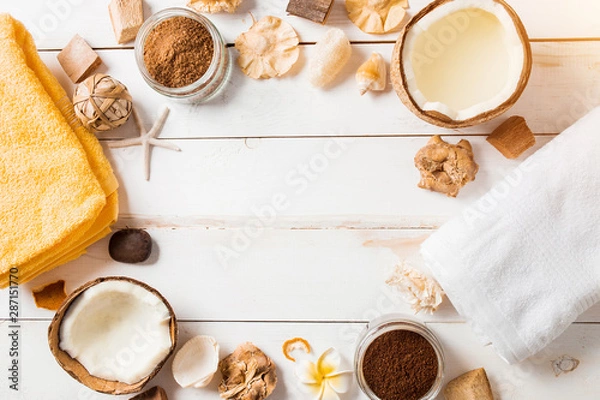 Fototapeta Coconut, spa products, coffee scrub, towels and seashells on white background