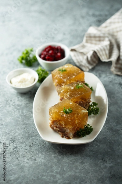 Fototapeta Festive meat jelly with sauces on white plate