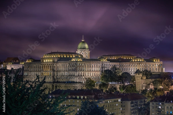 Fototapeta Budapest, Hungary - Beautiful illuminated Buda Castle Royal Palace at night with smoke at background after the fireworks of State Foundation Day