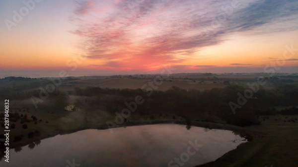 Fototapeta Nebraska countryside landscape trees, water, and sky with clouds